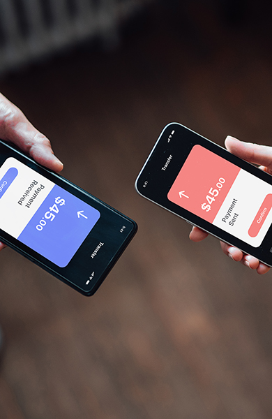 Closeup of two people managing online banking with smart phone