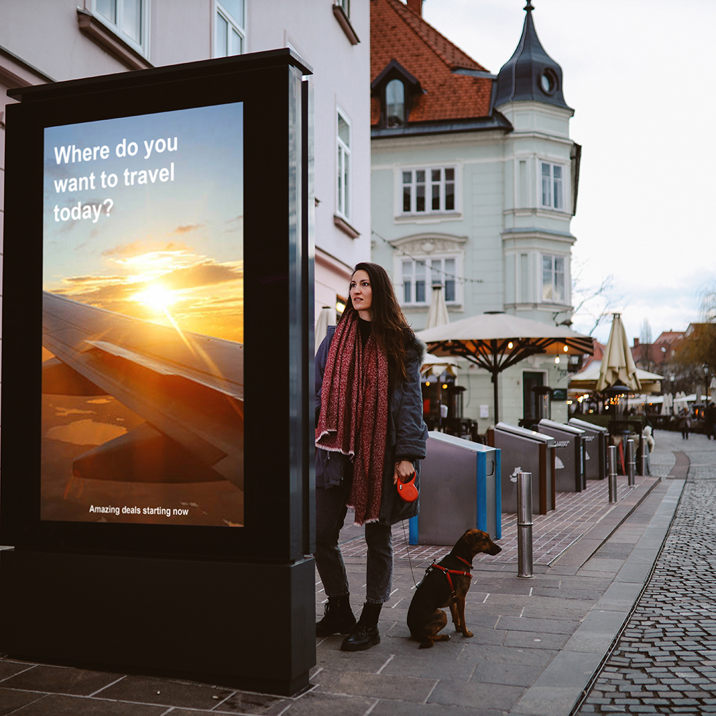 Woman in her late 30s looking at the electronic smart sign in the