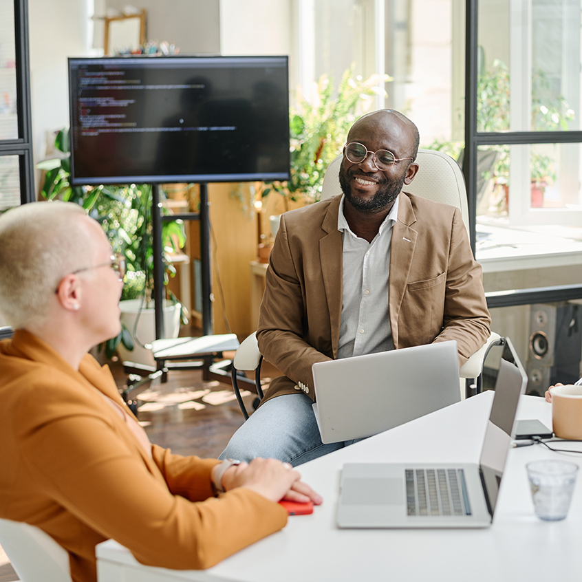 Team of programmers sitting at meeting