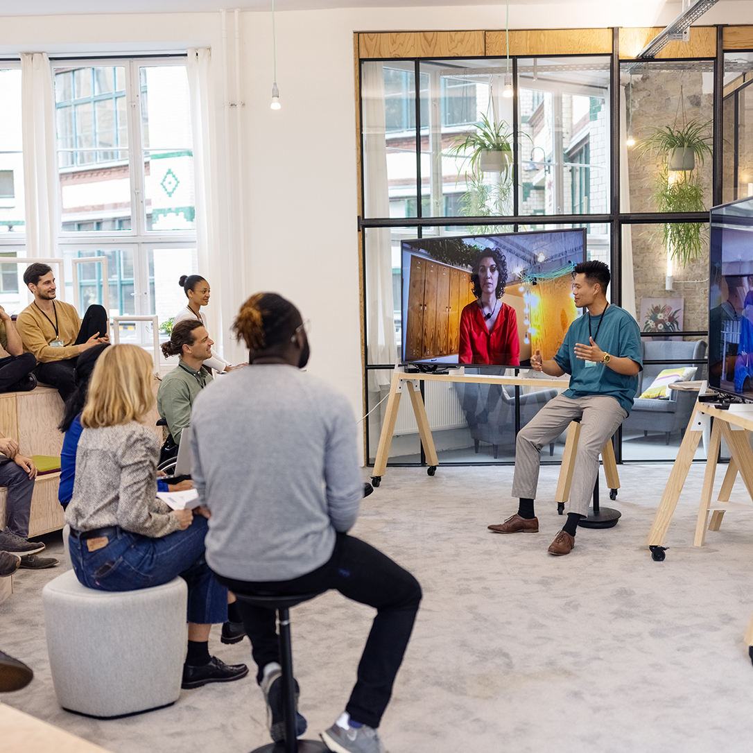 Business people having hybrid meeting in office