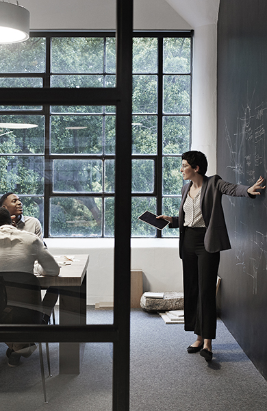 Businesswoman with coworkers in board room