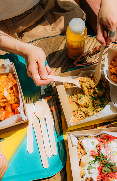 Elevated view of young mother and her little girl sharing food at healthy fast-food restaurant