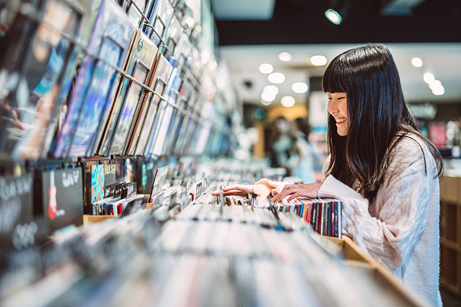 Teen girl enjoying vinyl shopping experience at an independent record store